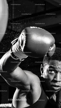 Focused boxer delivering a powerful punch in gym