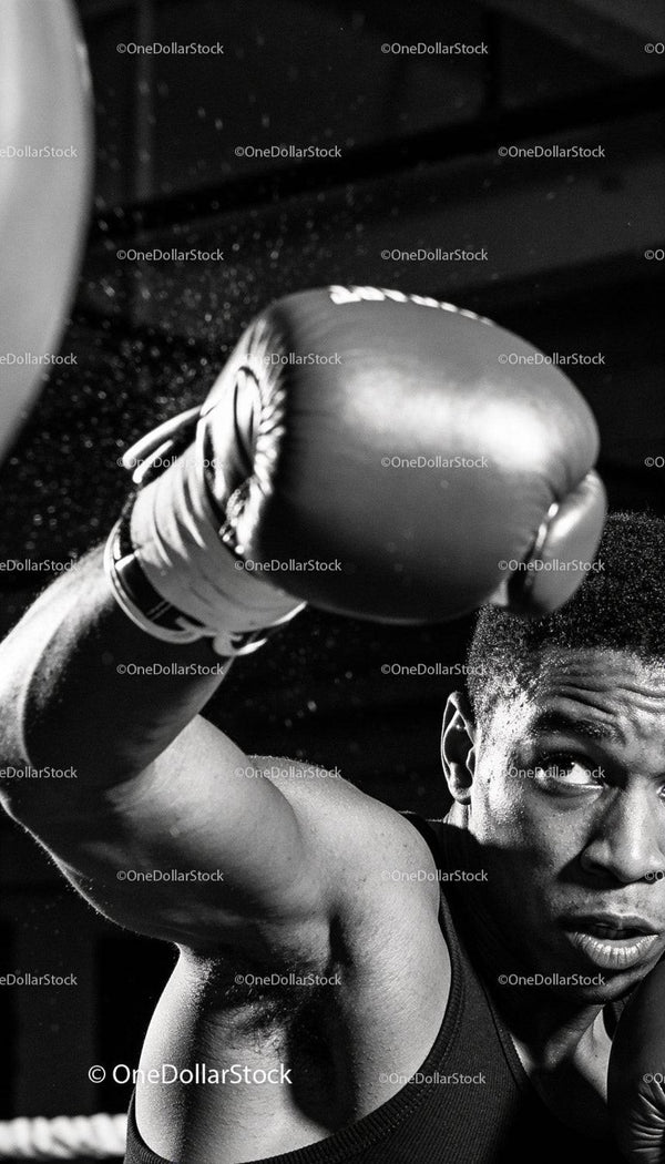 Focused boxer delivering a powerful punch in gym