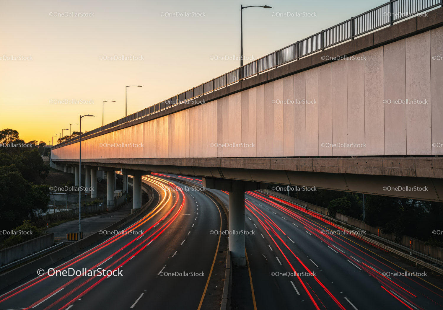 Cityscape with Overpass and Light Trails at Sunset