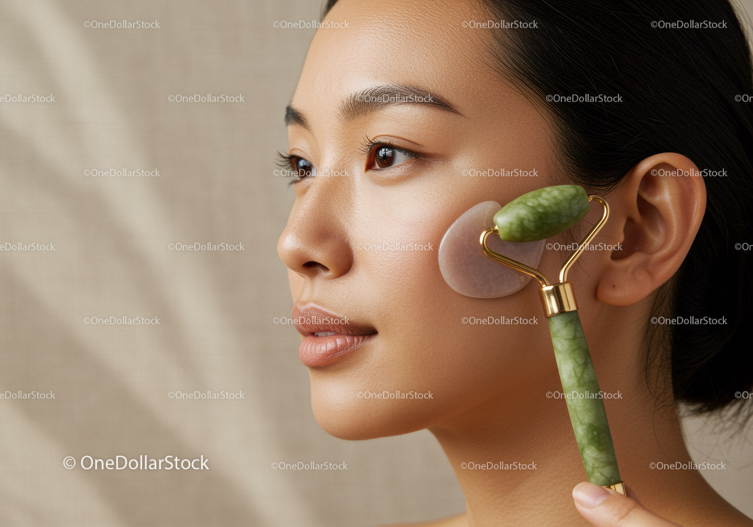 Woman Receiving Jade Facial Massage with Jade Roller for Skin Care
