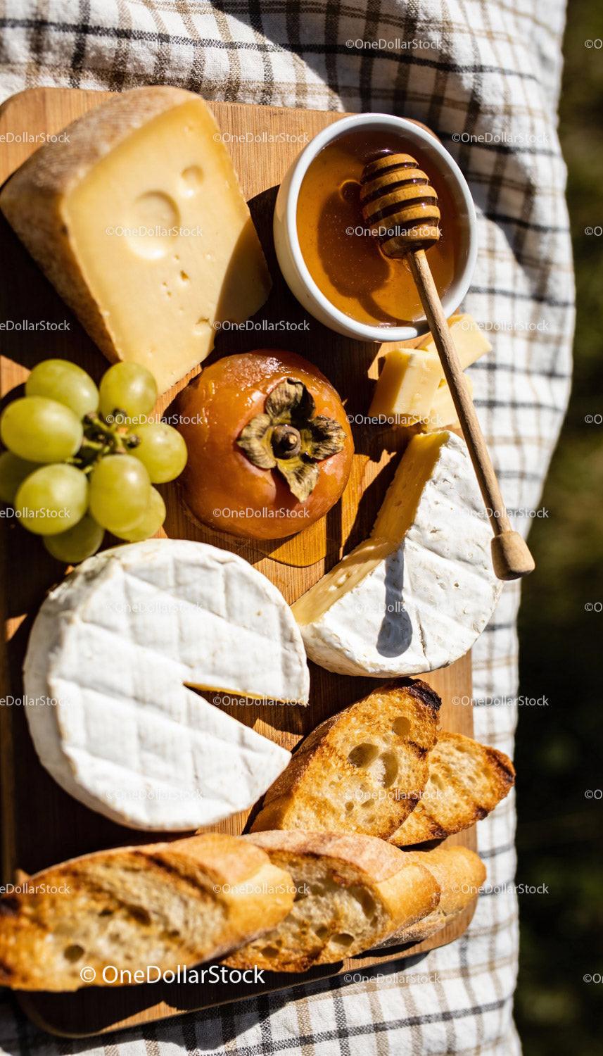 Assorted Cheese Board with Honey and Fresh Fruits