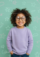 Smiling curly child with glasses in colorful studio