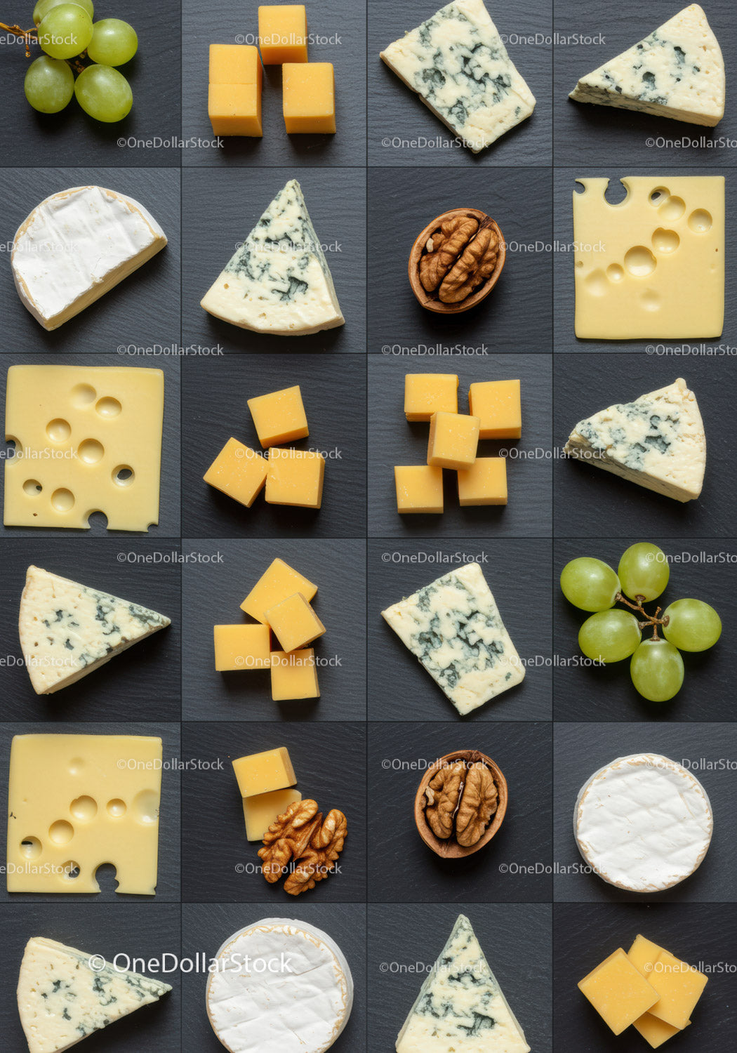 Assorted gourmet cheeses with grapes and walnuts on slate