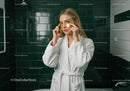 Young Woman with Golden Eye Patches in Spa Bathroom Setting