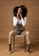 Stylish Confident Woman Sitting on Chair in Modern Studio