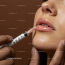 Close-Up of Lips Being Applied with Lip Gloss by a Makeup Artist