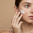 Close-Up of Woman Applying Moisturizer on Freckled Skin with Soft Background