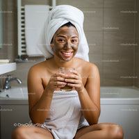 Happy Woman Enjoying Facial Mask and Herbal Tea in Bathroom