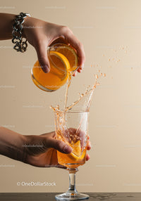 Refreshing orange cocktail being poured and splashing