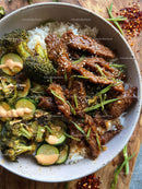 Beef Stir-Fry with Bok Choy and Cucumber Salad in a Modern Bowl