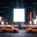 Busy urban street with yellow taxis and illuminated billboard