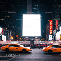 Busy urban street with yellow taxis and illuminated billboard