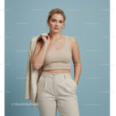 Stylish Woman in Beige Crop Top and Trousers Holding Blazer