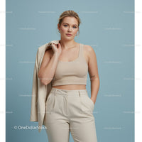 Stylish Woman in Beige Crop Top and Trousers Holding Blazer