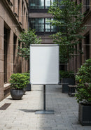 Blank whiteboard in modern urban courtyard with plants