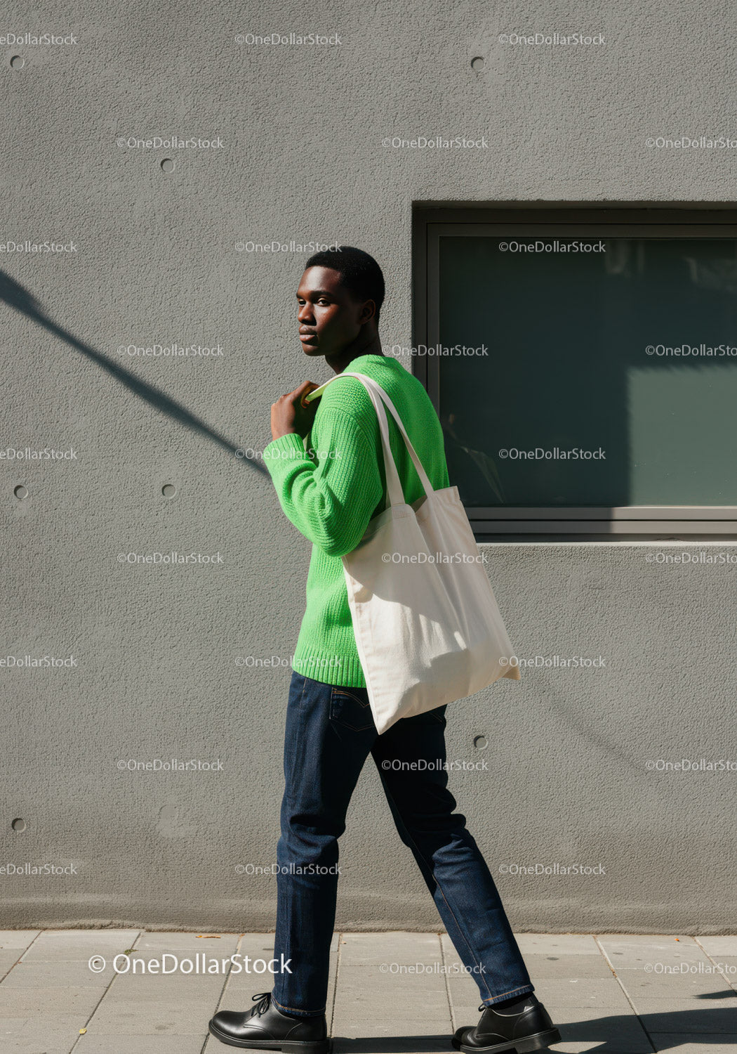 Young Man in Bright Green Sweater Walking with White Tote Bag in City