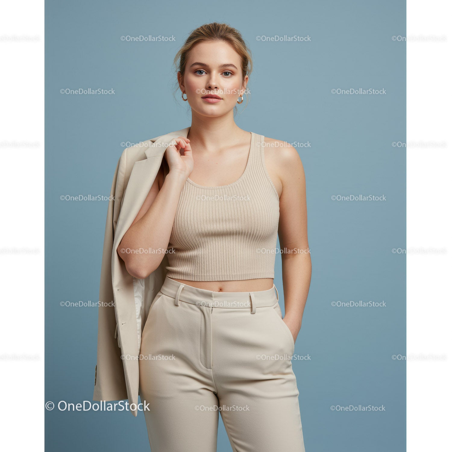 Elegant Woman in Beige Crop Top and Trousers Holding Blazer