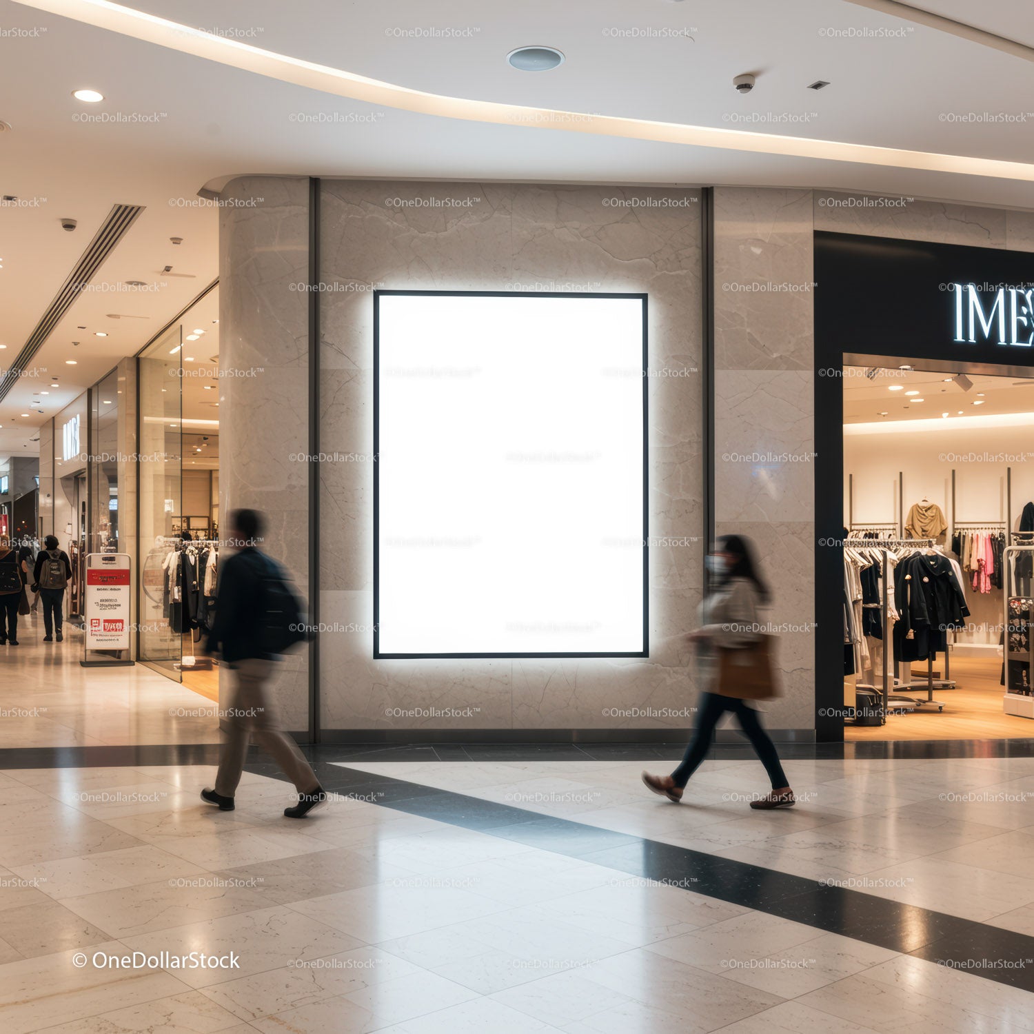 Busy shopping mall corridor with illuminated blank billboard