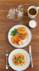 Traditional Polish breakfast with fried pancakes and pasta