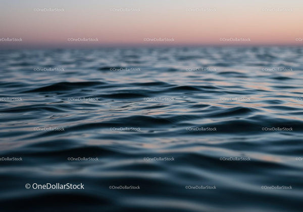 Serene Ocean Scene with Sunset and Gentle Waves