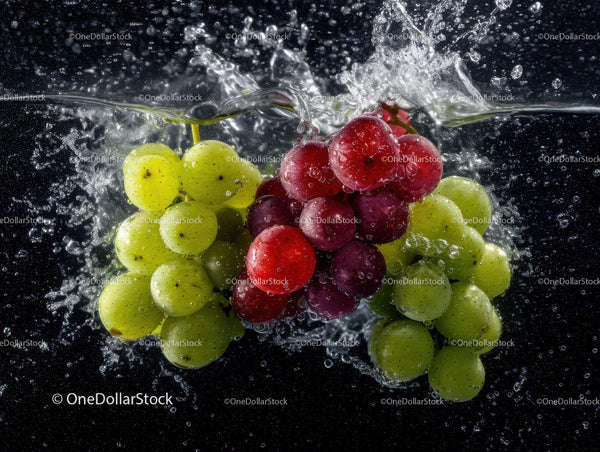 Assorted Green and Red Grapes Splashing into Water