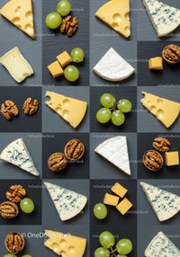 Assorted cheese wedges with grapes and walnuts on slate