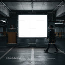 Man walking past illuminated billboard in parking garage