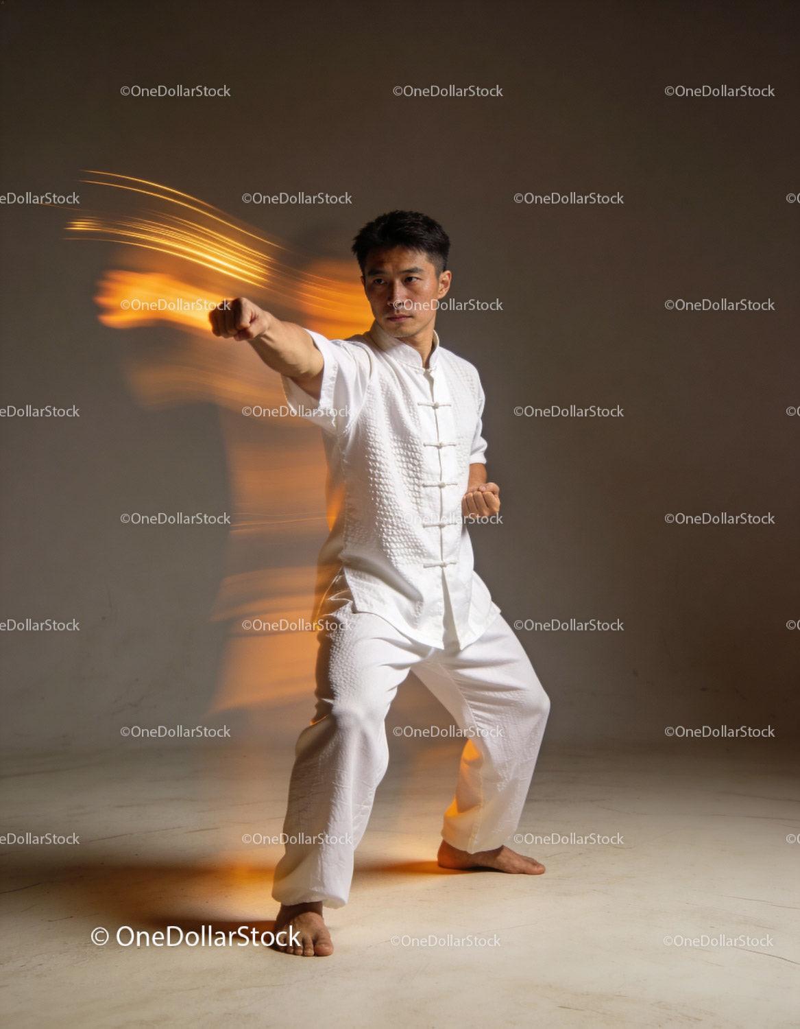 Martial artist performing powerful punch in white uniform