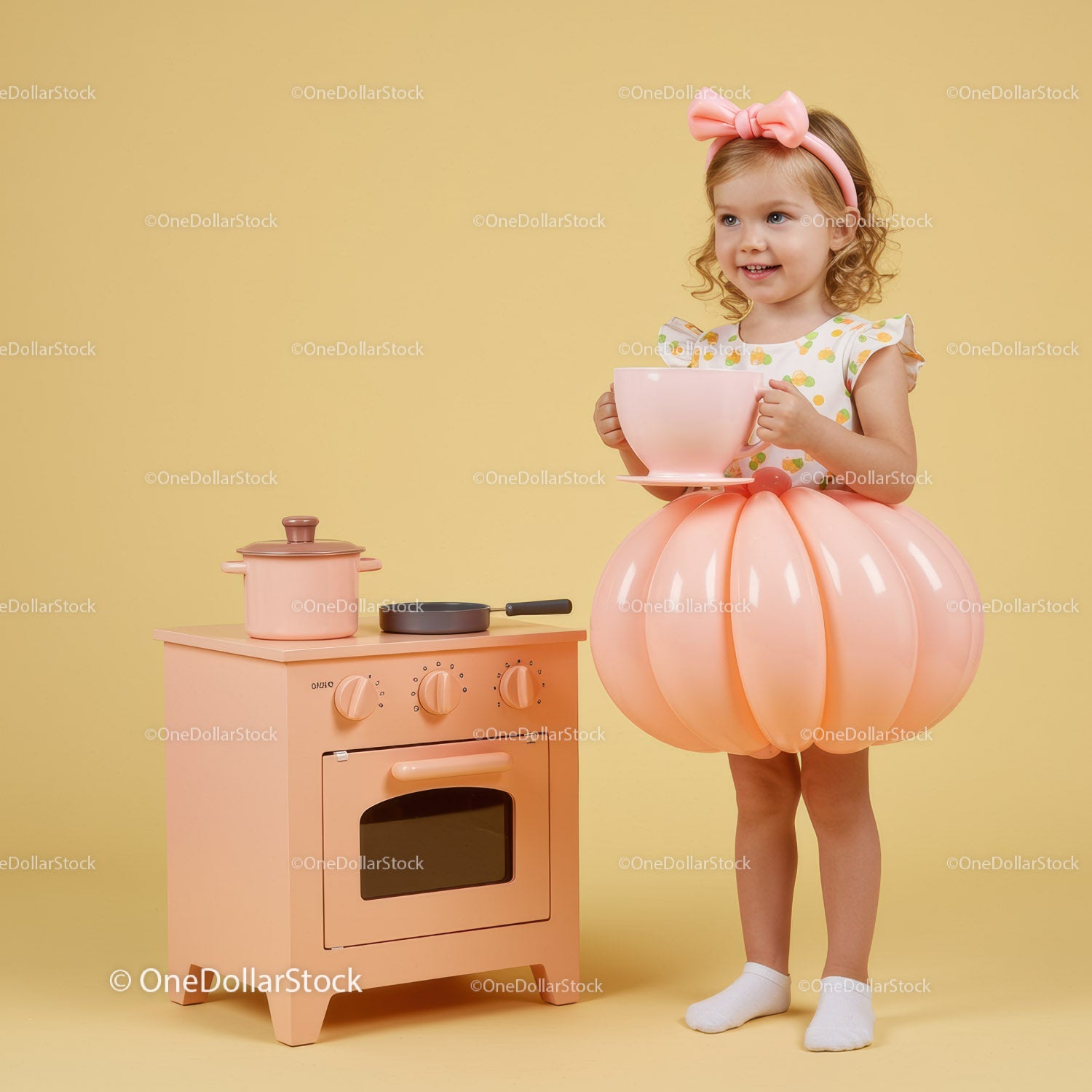 Little girl in balloon skirt holding oversized teacup