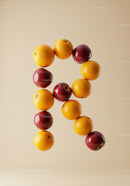 Creative letter R made from fresh fruits on beige
