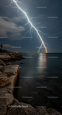 Powerful lightning strike over calm rocky coastline at night