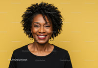 Smiling African American Woman with Curly Hair on Bright Yellow Background