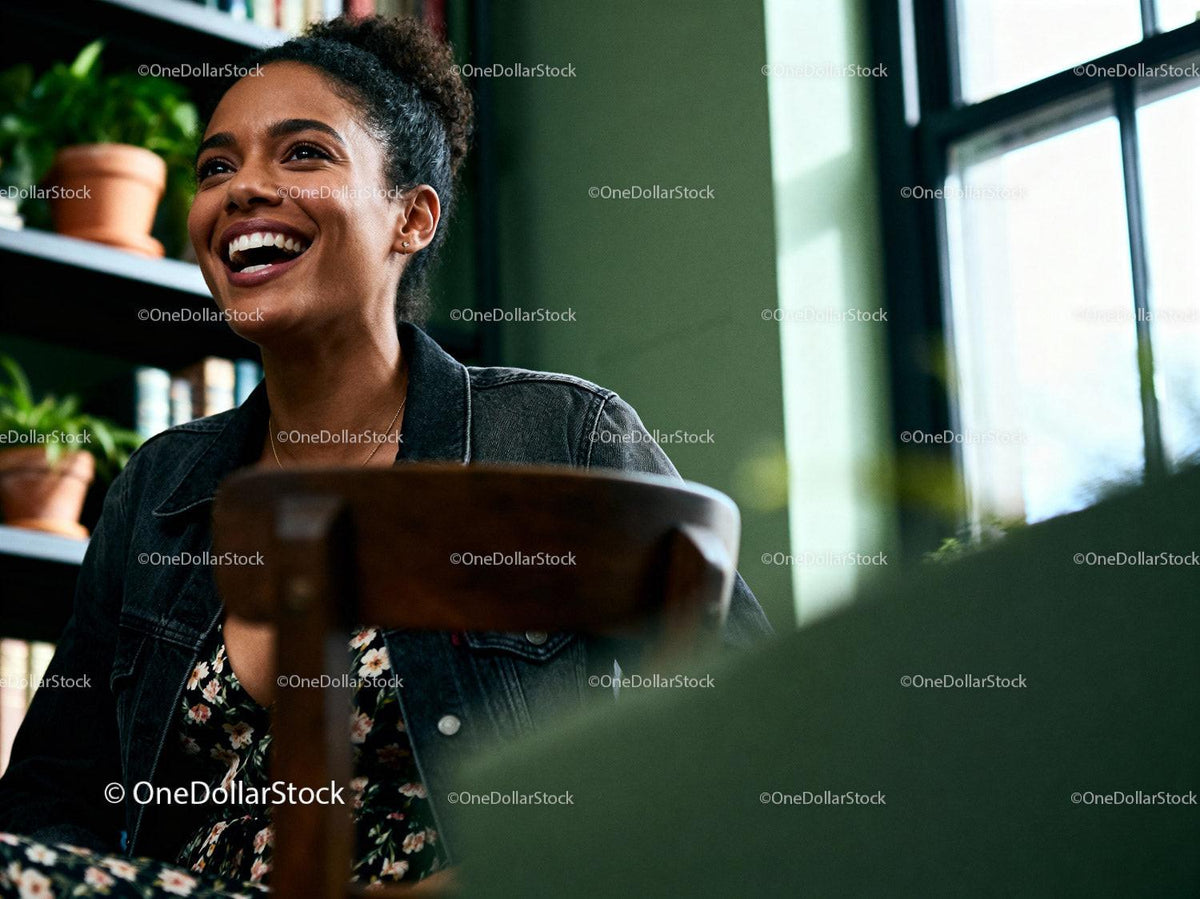 Joyful woman laughing in warm cozy interior