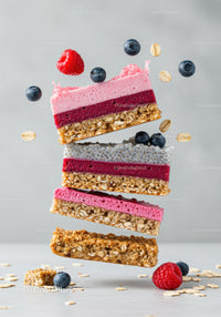 Stacked healthy berry oat bars with fresh fruits