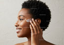 Portrait of a Woman Applying Lotion to Her Face for Healthy Skin