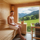 Relaxing Man Sitting in Wooden Sauna Cabin with Mountain View