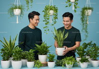 Two men enjoying indoor plants with green foliage