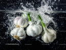 Fresh Garlic Bulbs and Green Onions Splashing Water in Kitchen