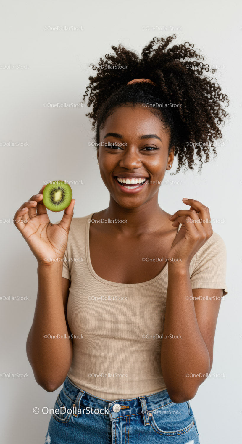 Young Smiling Woman Holding Kiwi Fruit in Casual Setting