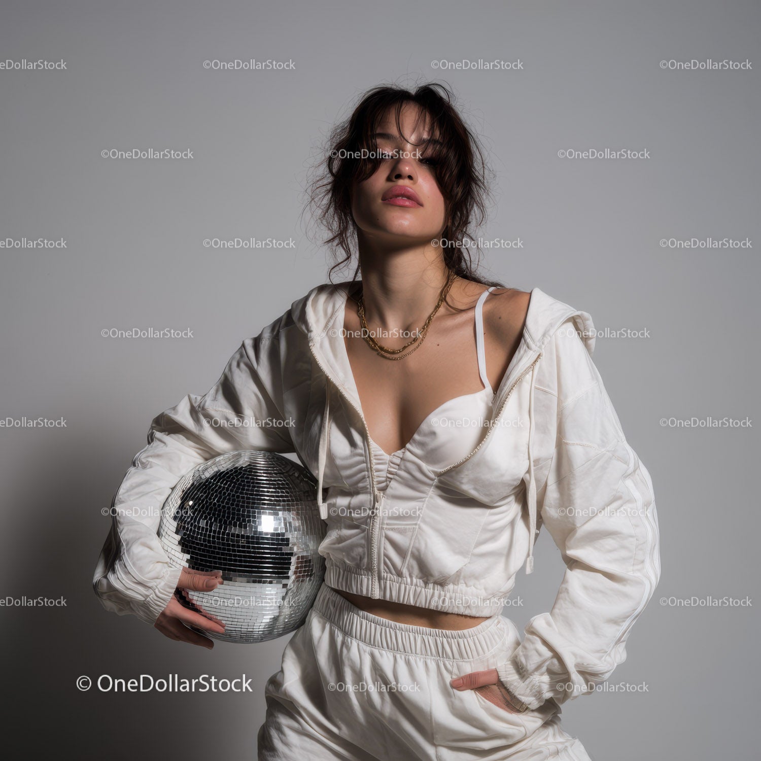 Stylish Woman in Metallic Outfit Holding Disco Ball for Modern Fashion