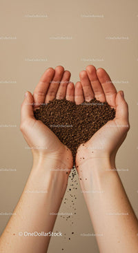 Hands gently holding falling soil granules close up