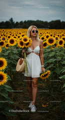 Woman in a Beautiful Sunflower Field Enjoying Summer Bliss