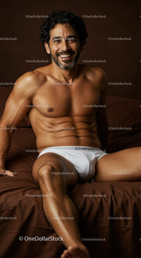 Smiling man relaxing on bed in white underwear