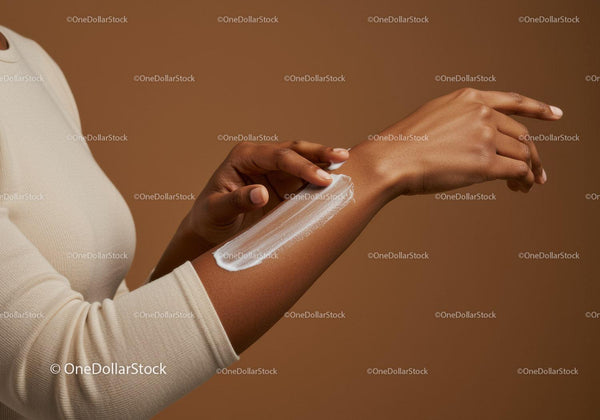 Close-up of Woman Applying Lotion on Arm for Skin Care
