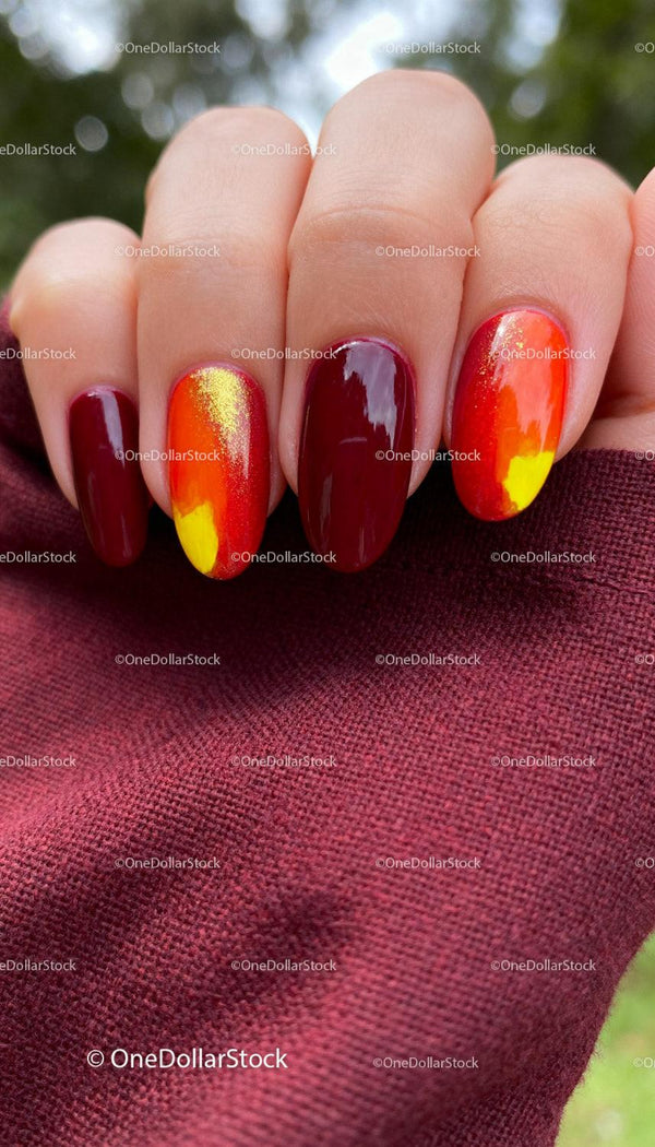Close-up of vibrant fall inspired manicure on hand