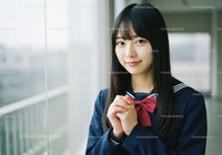 Young Girl in School Uniform Smiling Near Window on Rainy Day