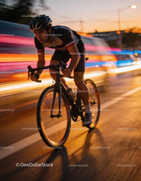 Focused cyclist speeding through city streets at dusk