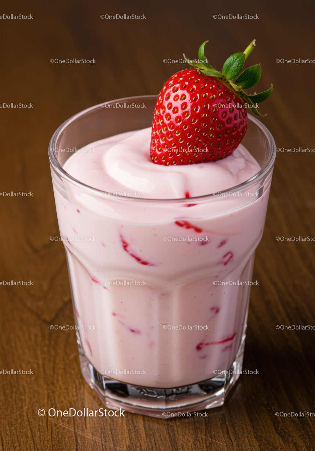 Fresh strawberry yogurt served in clear glass