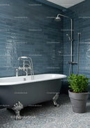Classic clawfoot bathtub with modern blue tile bathroom