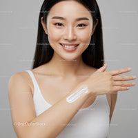 Young Woman Applying Lotion for Glowing Skin With Natural Makeup